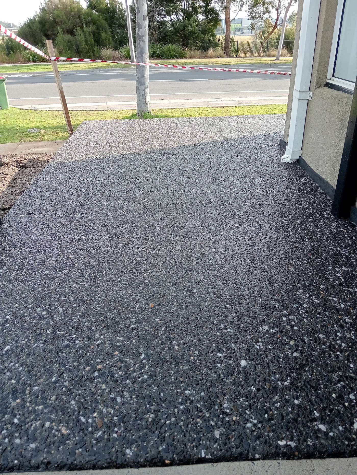 Finished exposed aggregate driveway alongside a Melbourne home